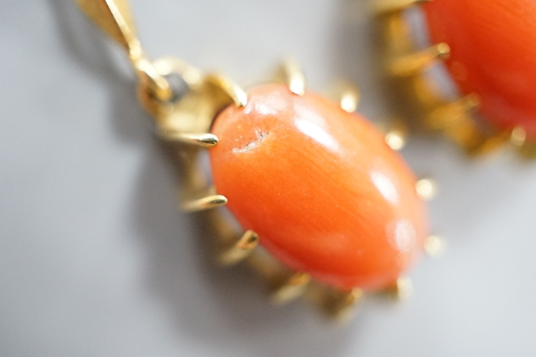 A pair of 18k and oval coral bead set drop earrings, 39mm, gross weight 6.8 grams.